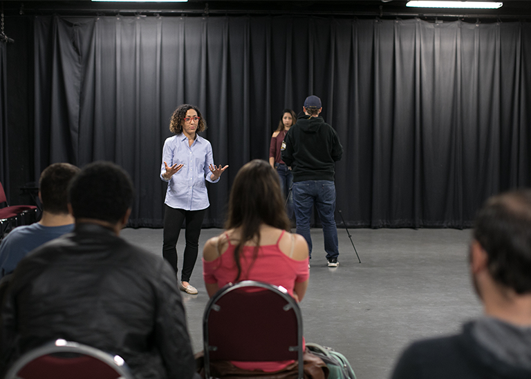 a professor lectures to a group of students